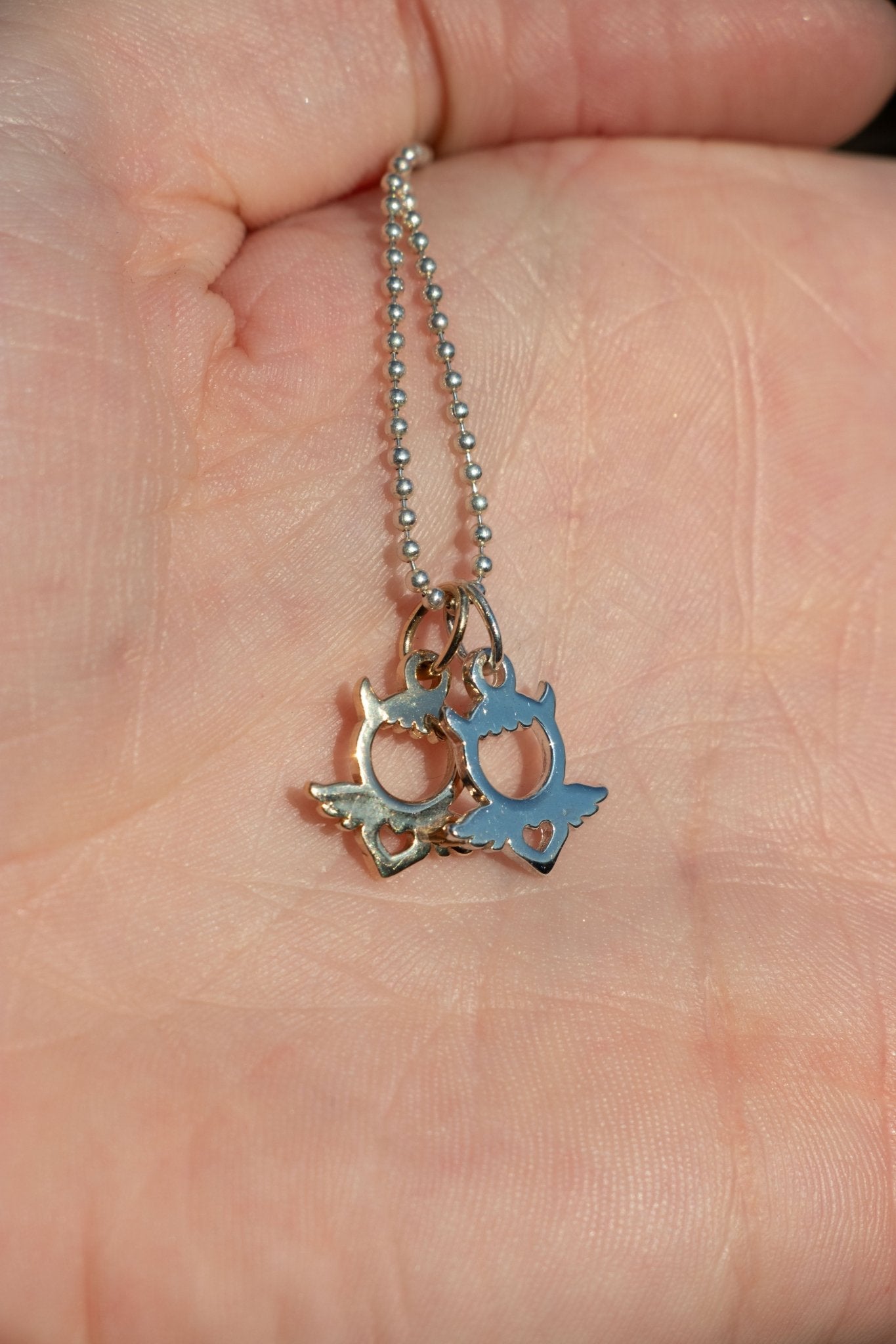 14k gold and sterling devangel charm miniature angel pendant queer trans jeweler lettuce goods 14karatdoll styled on a chain